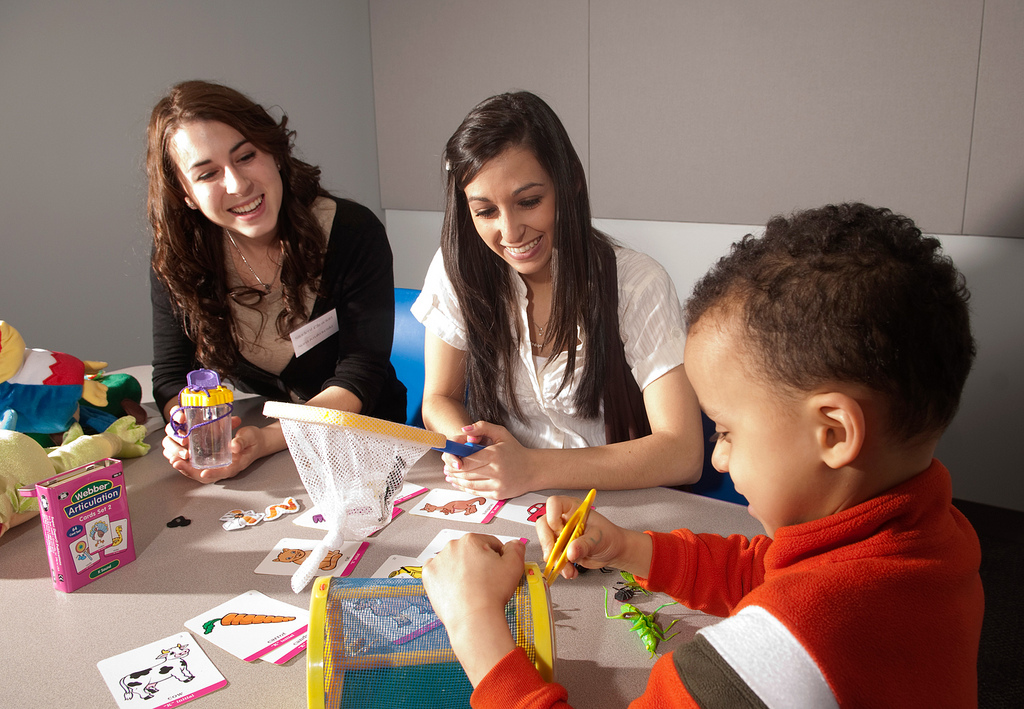 Students working along side of a child 